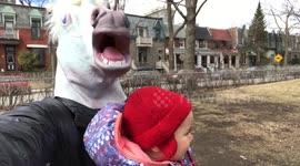 Dad babysits while wearing unicorn mask