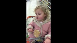 Sleepy toddler struggles to stay awake while eating lollypop