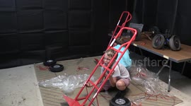 Boy gets bumped on head by falling furniture removal trolley