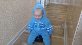 Adorable toddler rides a robot vacuum cleaner