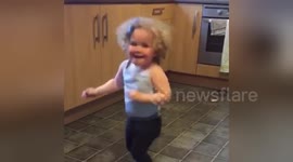 Toddler's funk dance to Bruno Mars sends her flying out of the kitchen