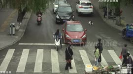 Toddler miraculously avoids being run over by cars by lying down on road
