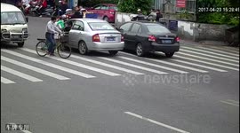 Toddler escapes being run over by car after dropping from a tricycle