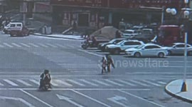 Police officer carries man on back to cross road