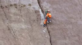 Firefighters rescue a boy stuck in crevice on sheer cliff