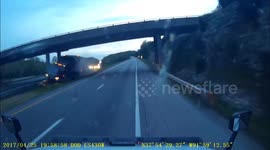 Semi crashes through guardrail.