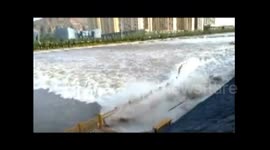 Rising river water sweeps pedestrians off their feet in northwestern China