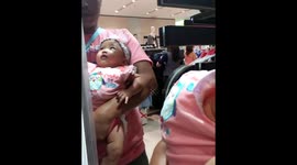 Baby sees her face in the mirror!