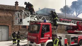 Firefighters are busy to extinguish a fire in a old house