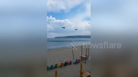 Military helicopters training over the sea