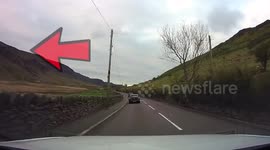 Low level RAF plane flying through welsh valley