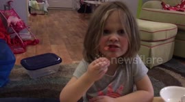 Little girl dry heaves on tomato