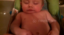 Baby falls asleep in Bathtub, Dad has a little fun