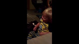Baby Laughing so hard he has to hold his face up