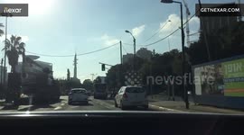 Crane truck topples street light onto car in TLV