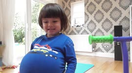 Funny toddlers use football as a babybump