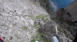 Flying fast, off the cliff, rocks, trees and flowers rush past