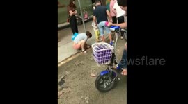 Citizens try to find treasure in mud and rubbish after rainstorm