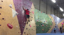 Climber scales indoor wall with no hands