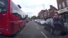 Woman trying to catch a bus narrowly avoids being run over by car