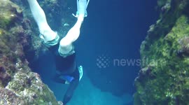 Divers explore Blue Hole Spring's underwater cave in Florida
