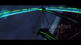 Illuminated hang glider swoops into Munich