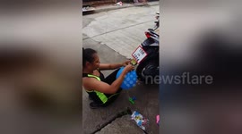 Woman uses bike exhaust pipe to inflate balloons