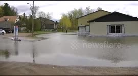 Man walks through flooded road