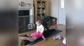 Mum exercising with one-year-old toddler