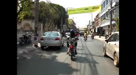 Dog rides freestyle on back of motorbike