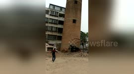 Giant chimney collapses on the top of demolition worker