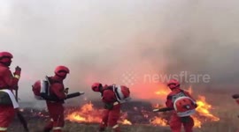 Firefighters battle huge forest fire in northern China