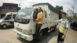 Man hanging out of lorry to avoid overloading