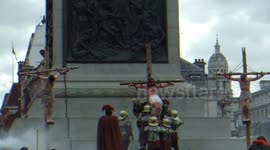 Crowds watch a portayal of Christ's crucifixion - London