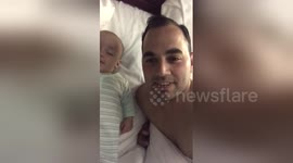 Sleepy baby smiles when his dad says 'I love you'