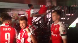 Arsenal players climb up to collect FA Cup