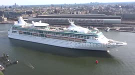 Huge cruise ship leaves Amsterdam port (aeriel view)