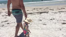 Baby's first time in the ocean- Priceless Reaction