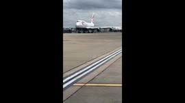 Suitcase blown across runway at Heathrow airport