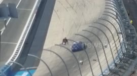 Fan climbs the fence at Dover.