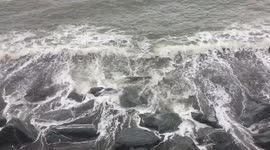 Waves crashing against the rocks in Aberystwyth