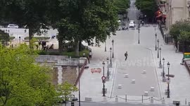 People running in front of Notre-Dame cathedral in Paris