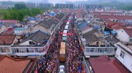 Aerial footage of crowd giving send off to students taking university entrance exam