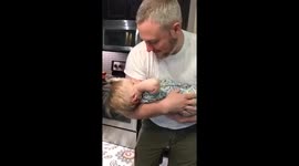 Baby doesn't like father's singing and plugs his ears