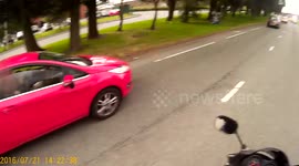 Woman driving  using her phone to facebook with her small child  beside her