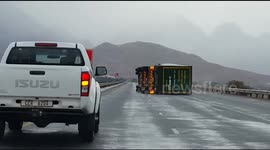 Truck/ lorry loses wheel and overturns due to inclement weather in South Africa