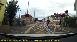 A Man Jumping Over Train Crossing Barriers