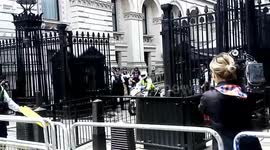 People protest outside Downing street as Theresa May leaves to meet the Queen