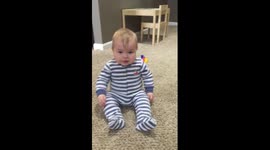 Baby sad that he can't clap his hands