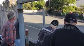 Crowd gasps as rider crashes into barrier during Isle of Man TT